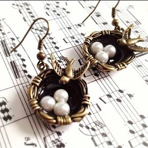 Pair of bronze metal Bird with Nest and eggs earrings.